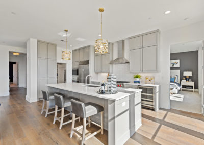Modern condo kitchen with large island and high-end finishes.